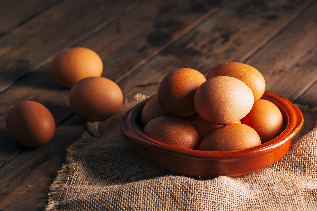 Chicken eggs on napkin on wooden table