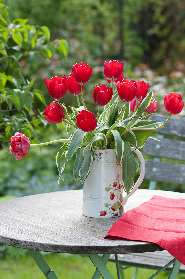 Bouquet of red tulips in a jug