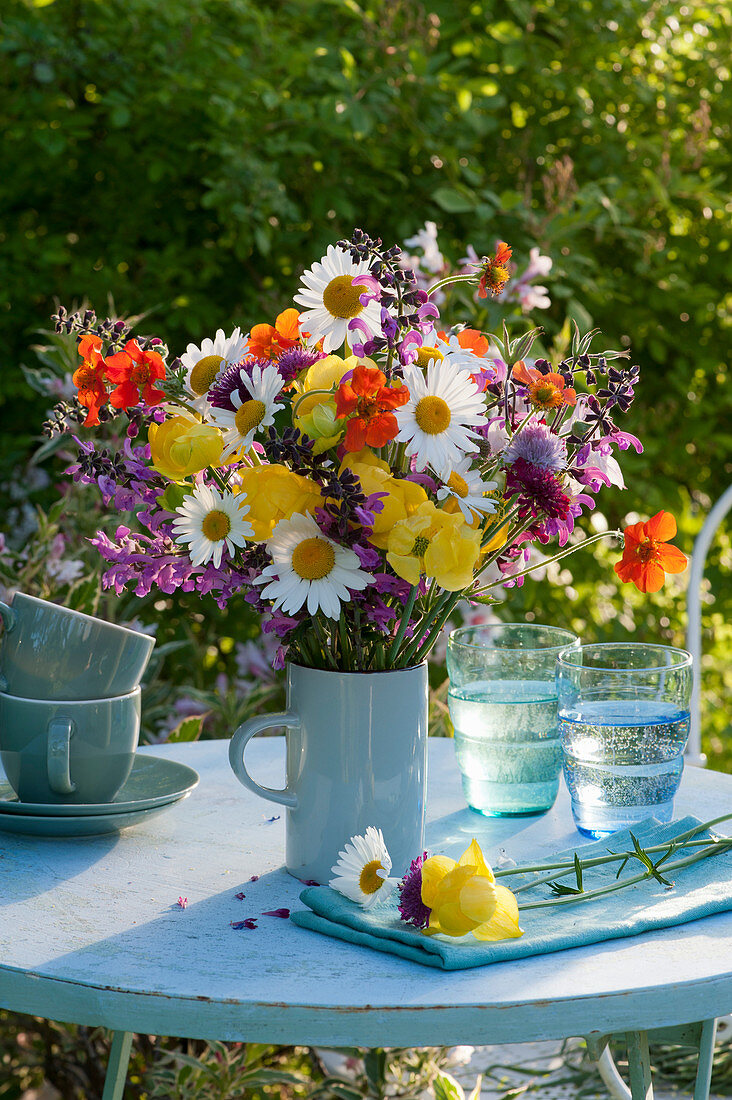 Early summer bouquet of daisies, globeflowers, clove root, meadow sage and widow flower