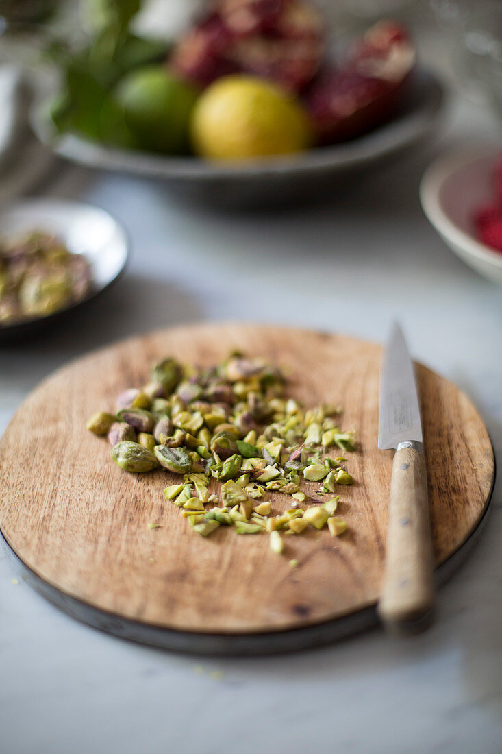 Chopped pistachio nuts on a wooden board