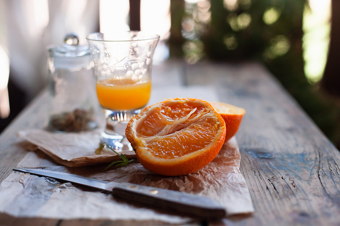 Sliced orange and orange juice on a wooden table