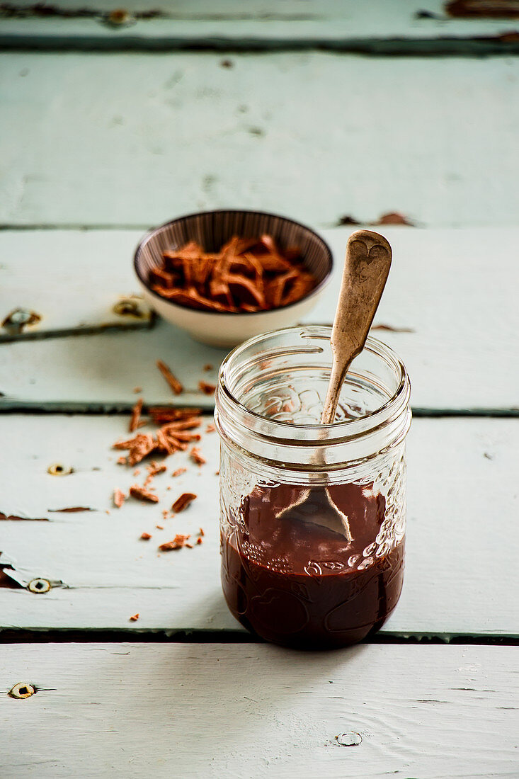 Melted dark chocolate in glass jar