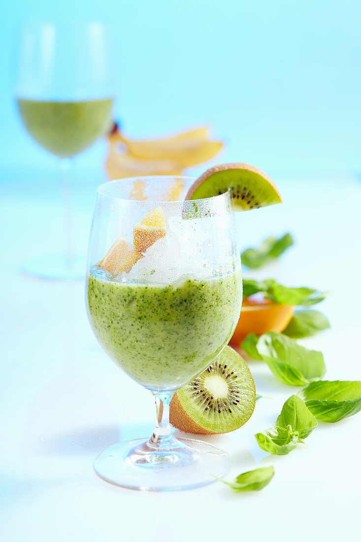 Green power smoothie with lambs lettuce, various fruits, basil and ginger