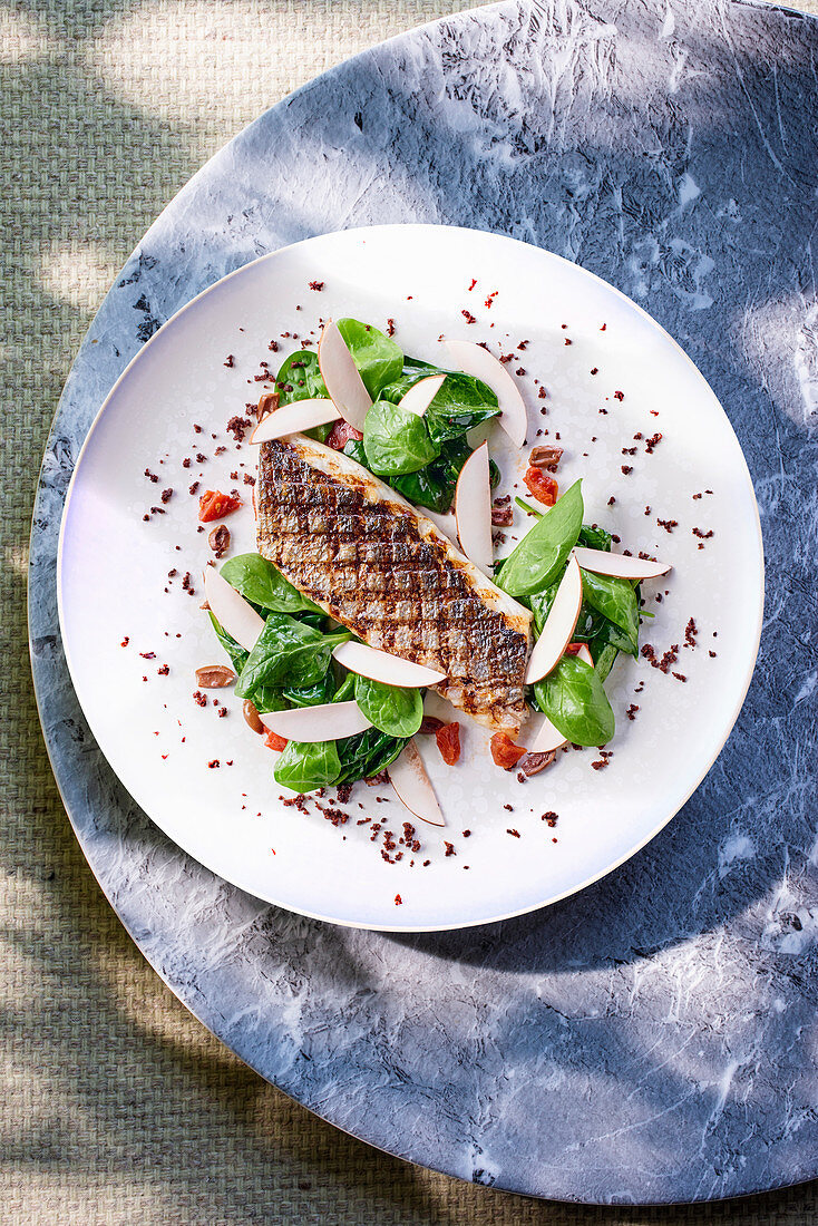 Grilled sea bass with spinach and mushrooms