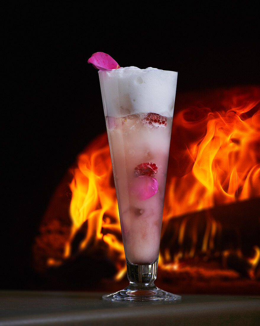 A cocktail in front of a log fire