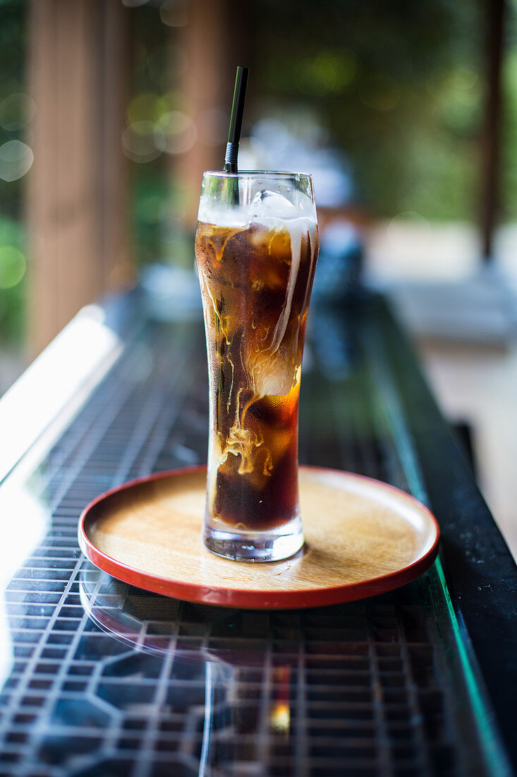 Cold brew in a glass on a table outside