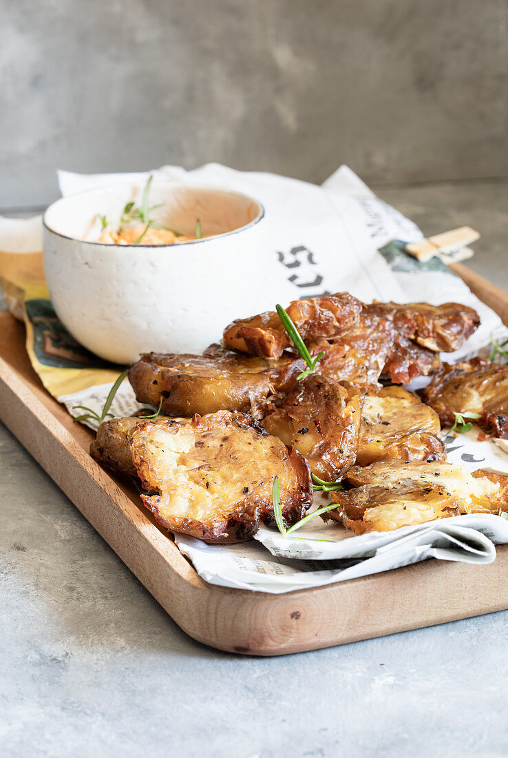 Roasted smashed potatoes with a harissa and tahini dip