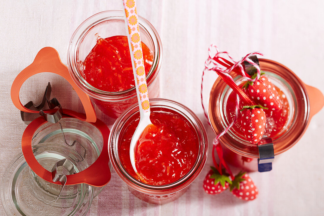 Jars of strawberry and carrot jam with decorations