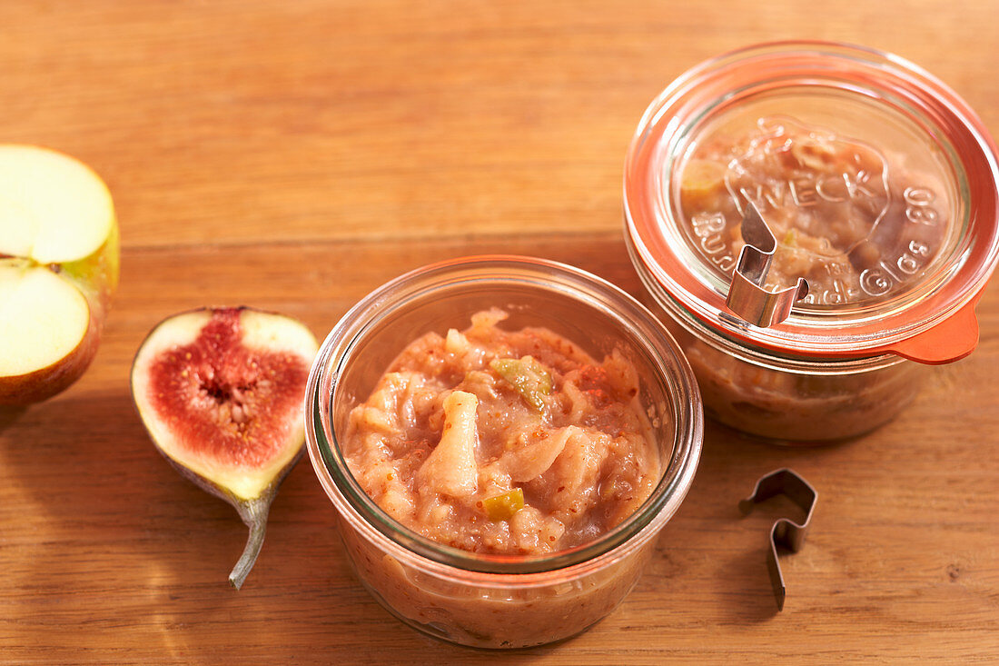 Homemade apple chutney with figs in mason jars