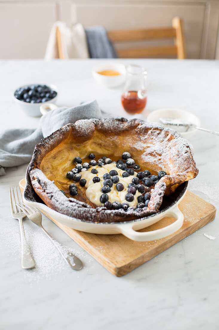 Dutch baby pancake with cream and blueberries