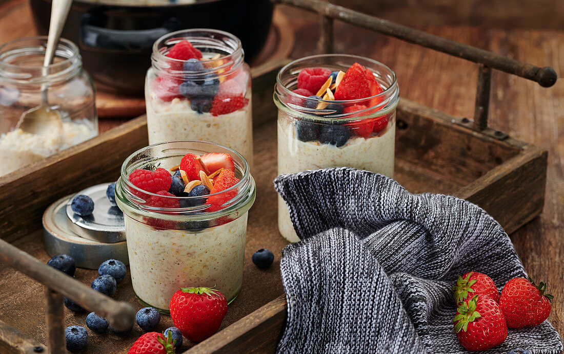 Fruity millet porridge with mixed berries in a mason jar