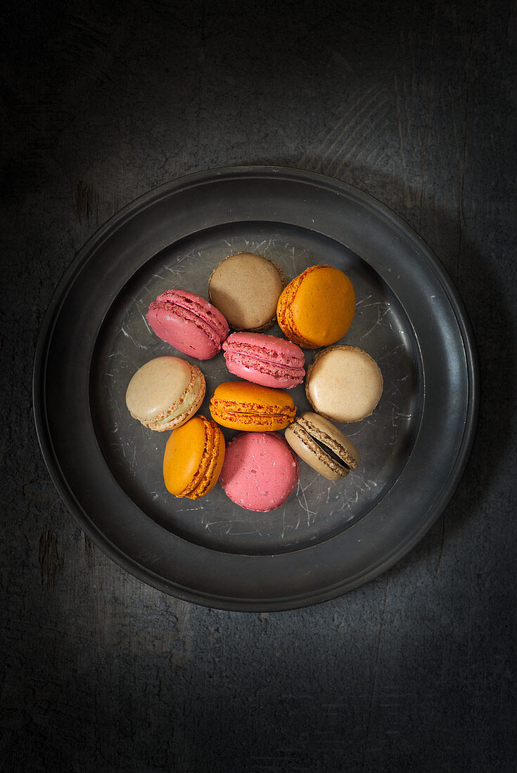 Various macarons on a grey plate