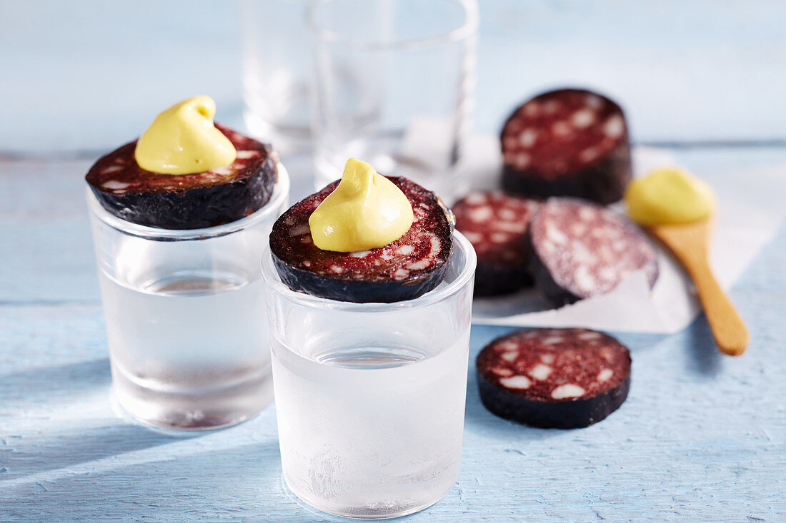 Swabian tequila with a slice of black sausage and mustard