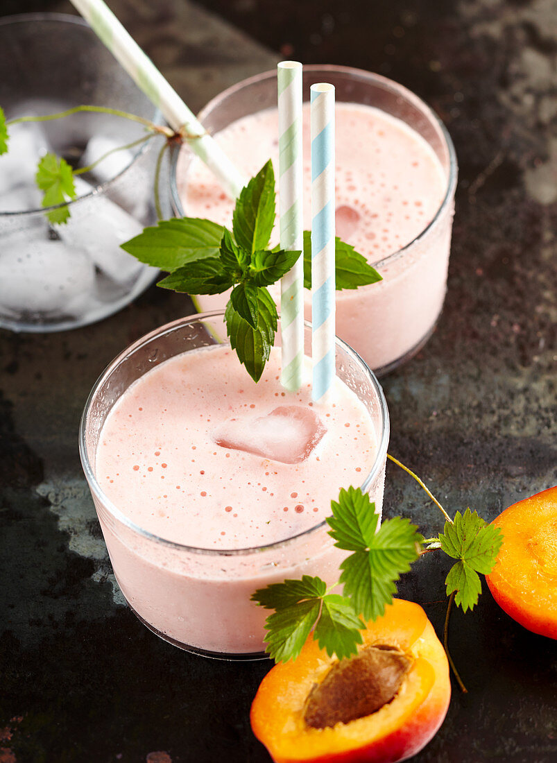 Fresh apricot smoothie and strawberries with milk