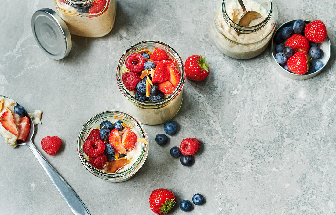 Fruity millet porridge with mixed berries in preserving jars
