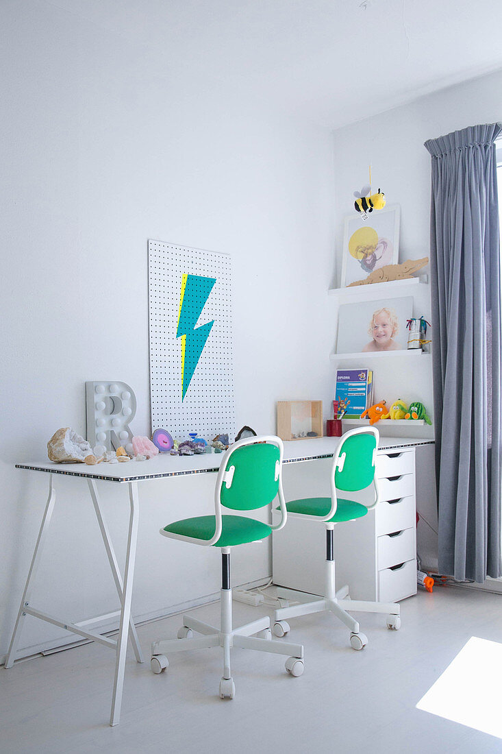 White desk and green-and-white office chairs