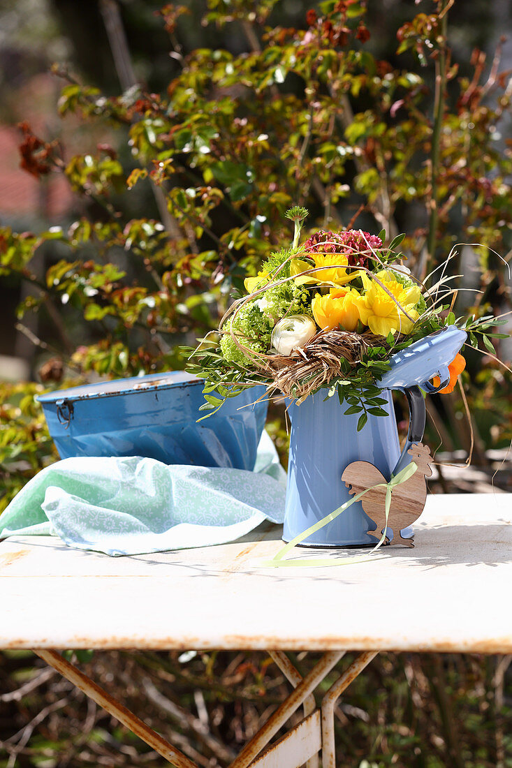 Rustic spring bouquet in blue enamel jug