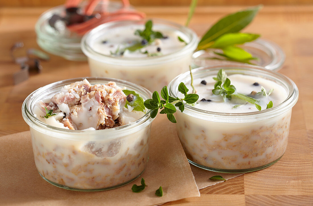 Pork rillettes canned in mason jars with fresh herbs