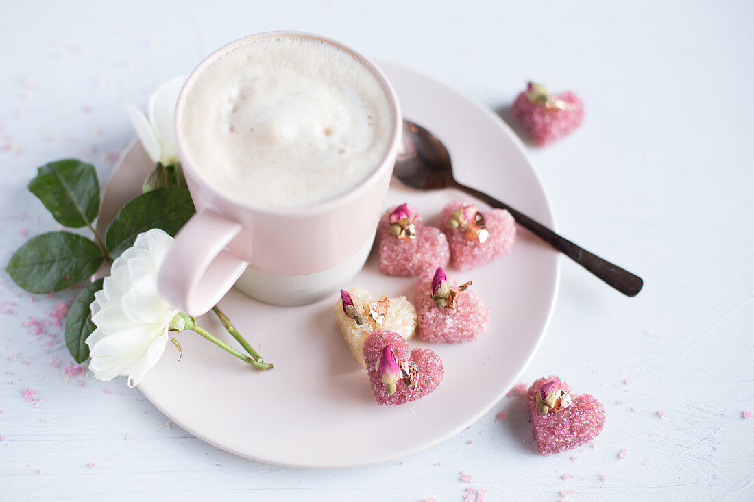 Cappuccino with heart-shaped, rose sugar cubes