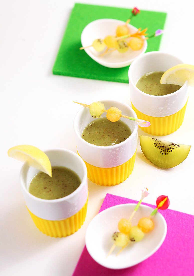 Kiwi and melon smoothie shots with fruit skewers
