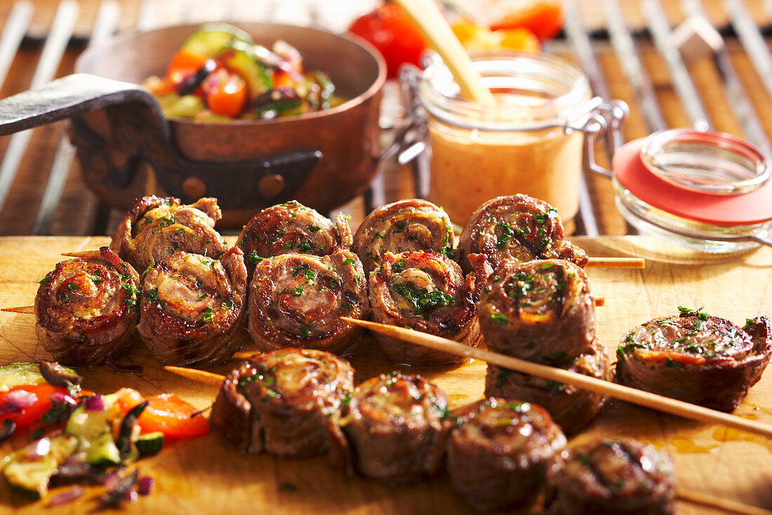 Grilled roulade skewers with Mediterranean vegetables and spicy BBQ sauce