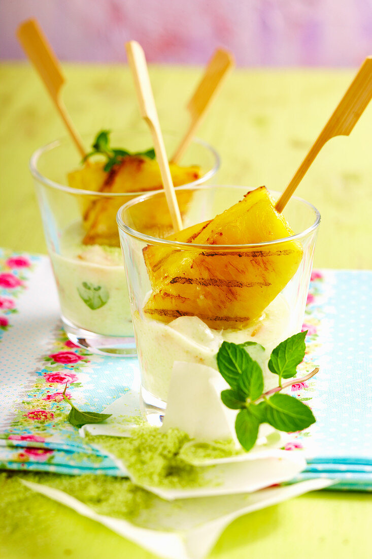 Grilled pineapple with mint yoghurt in glasses