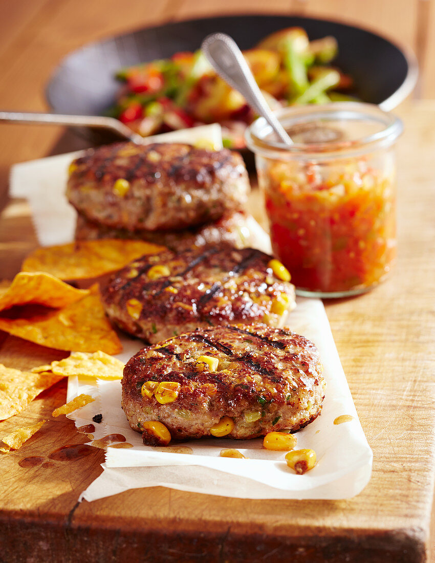 Meat patties with salsa, sweetcorn, potatoes and tortilla chips (Mexico)