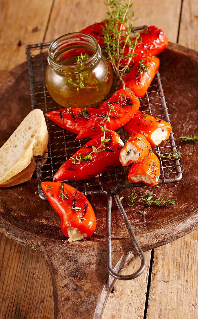 Grilled mini pointed peppers filled with feta cheese, white bread and thyme