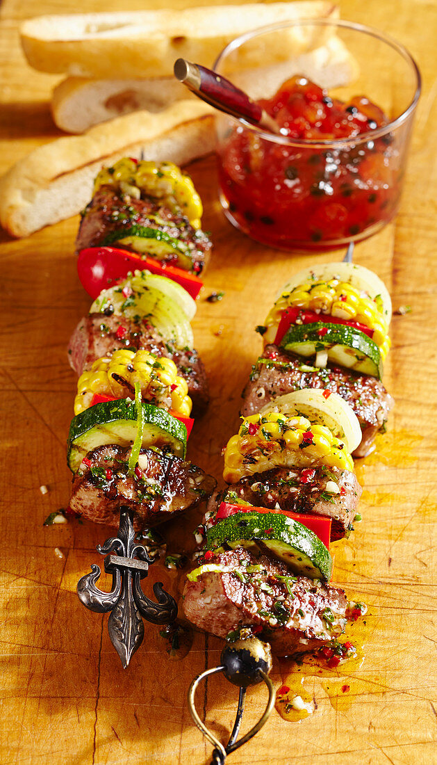 Grilled Australian lamb skewers with a spicy papaya chutney and white bread