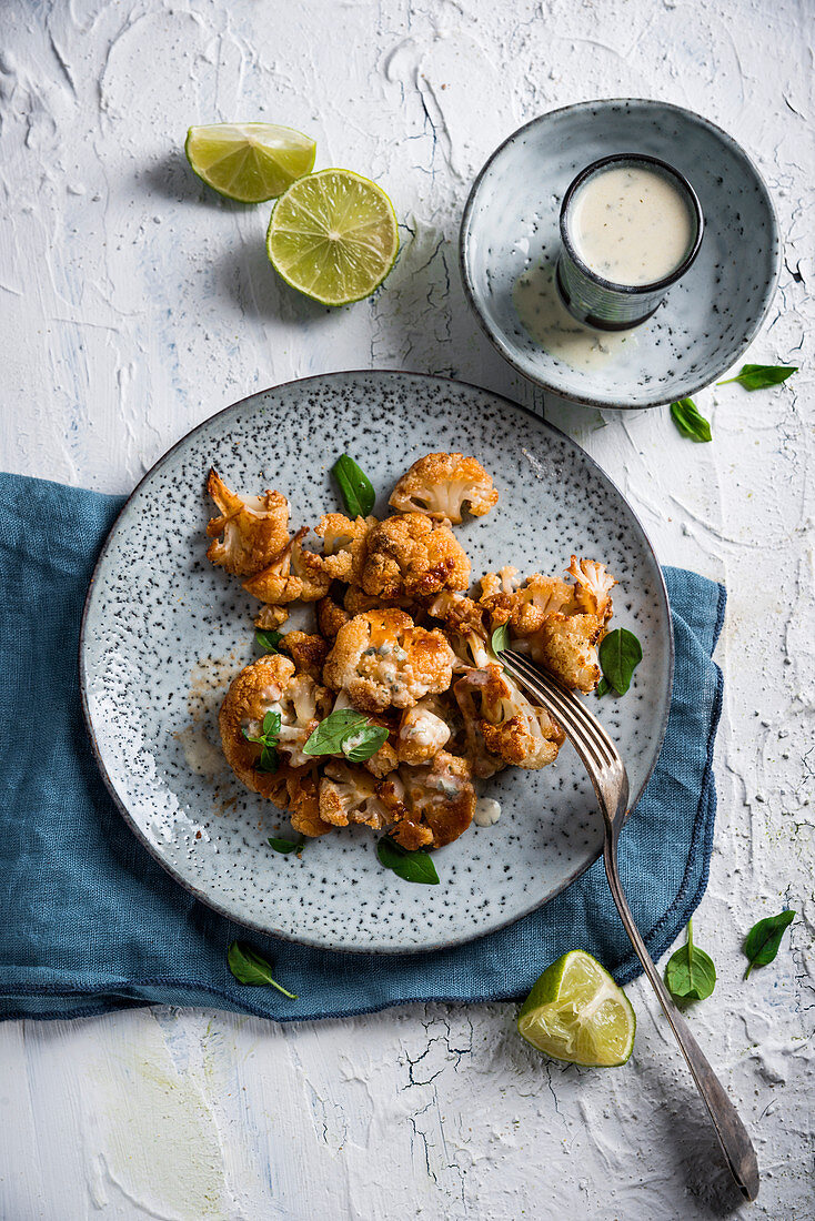 Spicy marinated, oven-baked cauliflower with a herb sauce