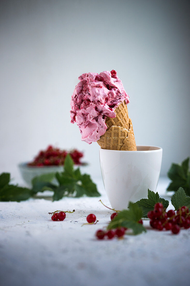 Vegan redcurrant ice cream in a cone