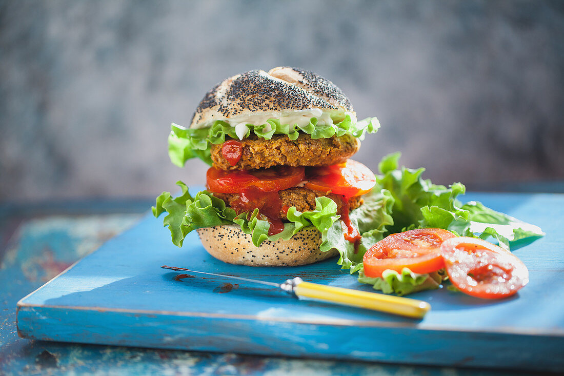 A veggie burger with tomatoes and lettuce