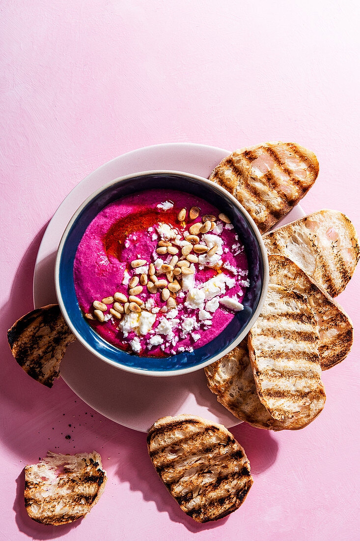 Whipped feta and beetroot dip with pine nuts and olive oil