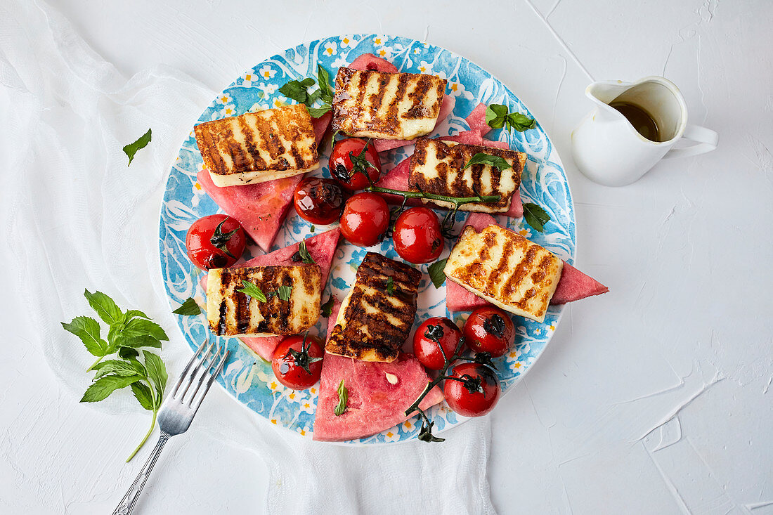 Watermelon, grilled halloumi and cherry tomato drizzled with olive oil, mixed with fresh mint and basil