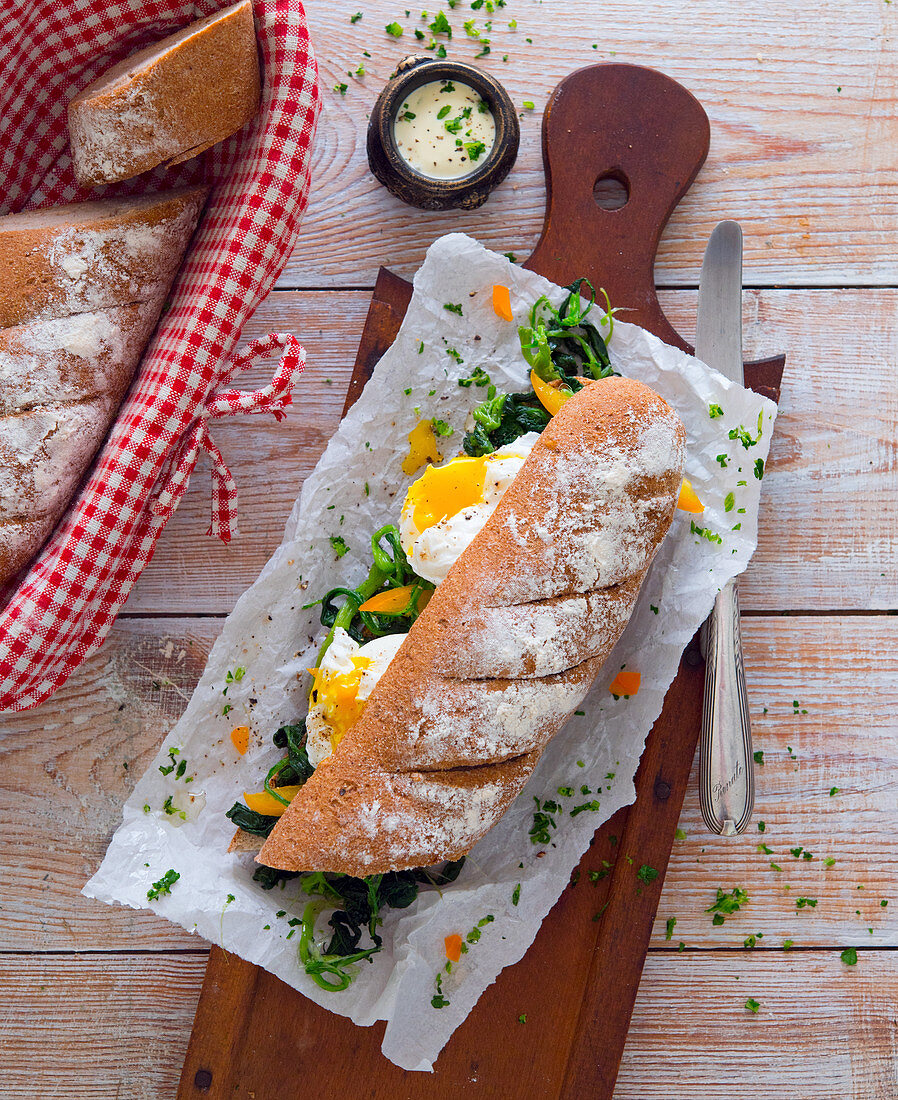 A sandwich with spinach and poached egg