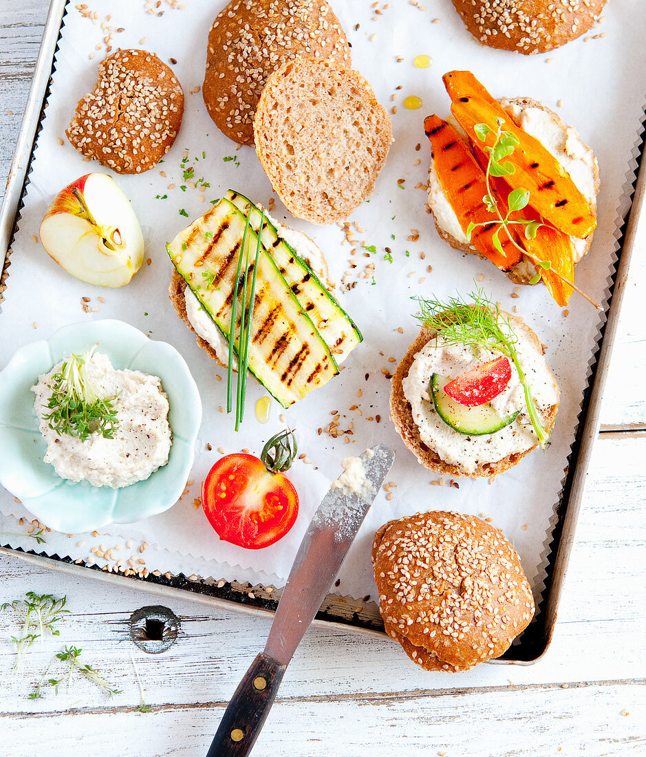 Sesame seed wholemeal rolls with vegetarian toppings