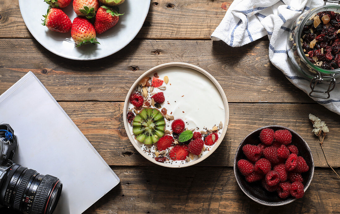 Dessert with red strawberry and raspberry in bowl composed with camera