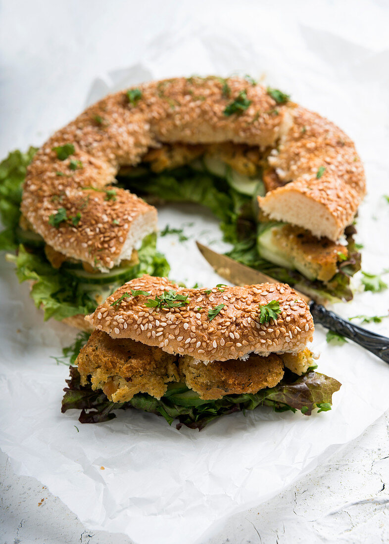 Simit (Turkish sesame seed wreath) with falafel, salad, cucumber and herbs – vegan