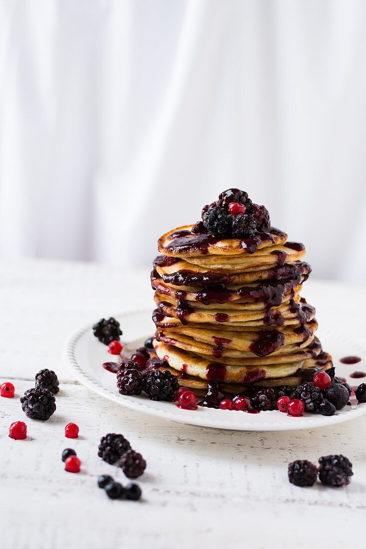 Pancakes with berry sauce and fresh berries