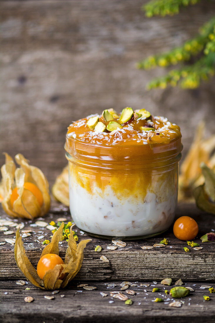 Coconut yoghurt with oats, physalis jam and pistachio nuts