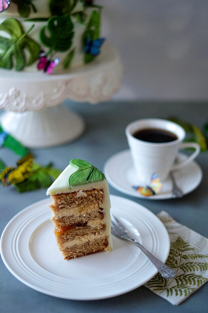 A slice of jungle cake with a cup of coffee