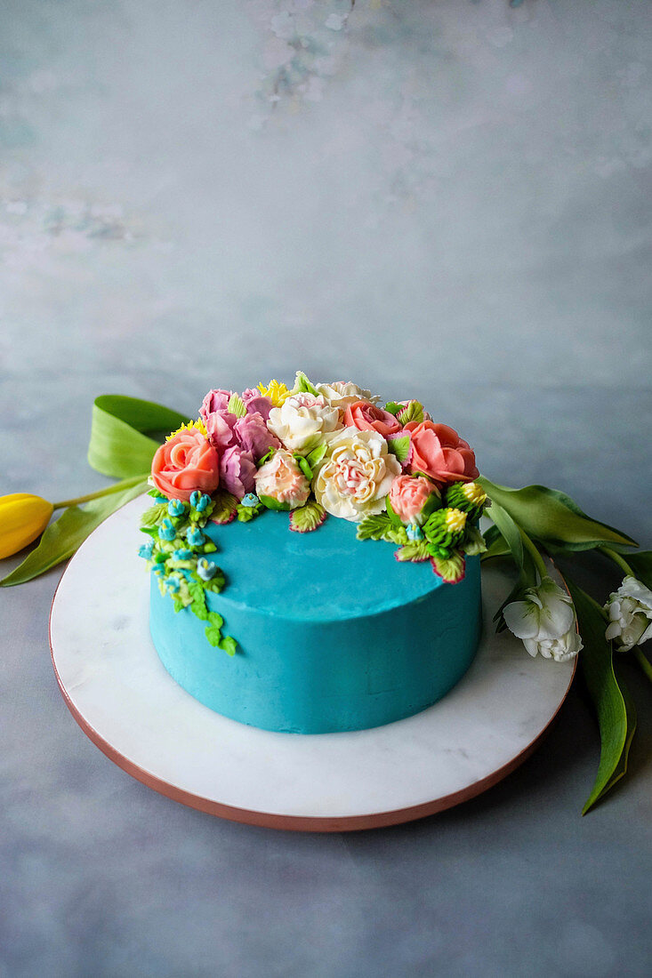 An exotic butter cream cake decorated with flowers