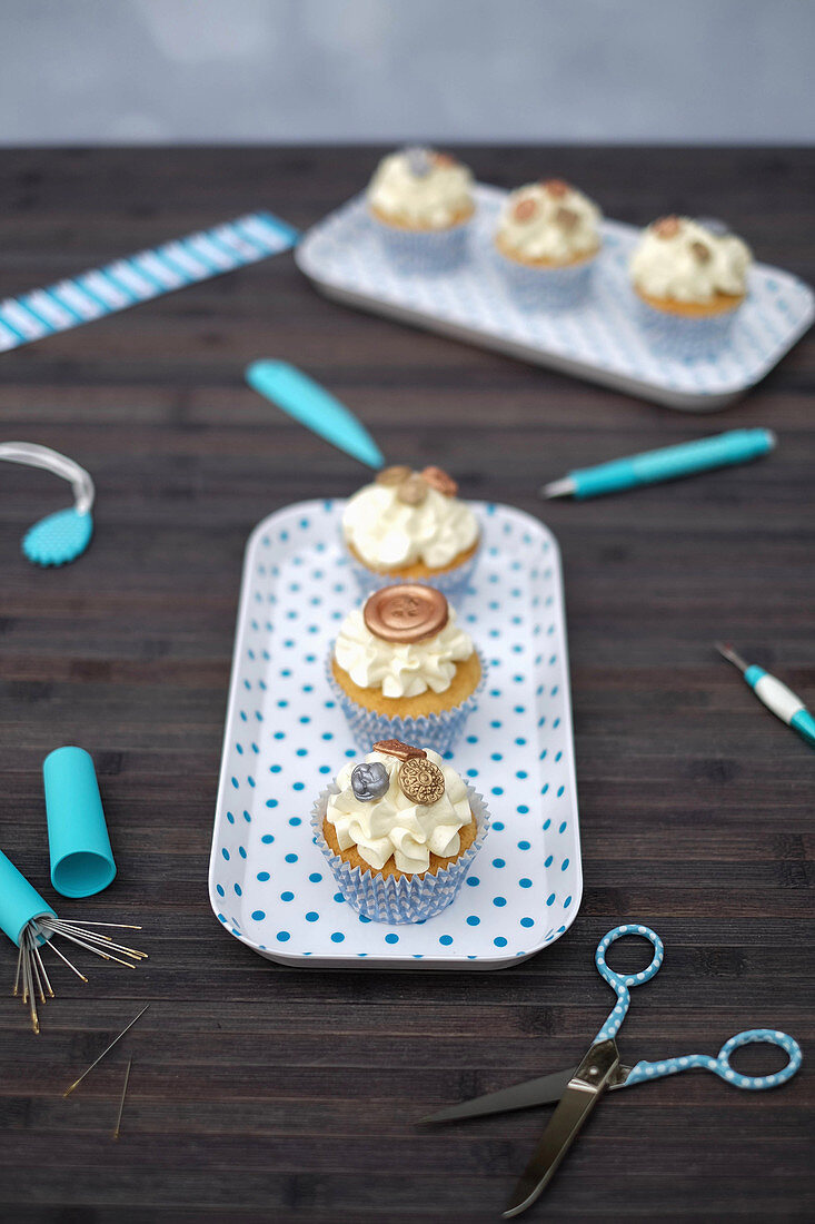 Cupcakes with vanilla cream and button decorations