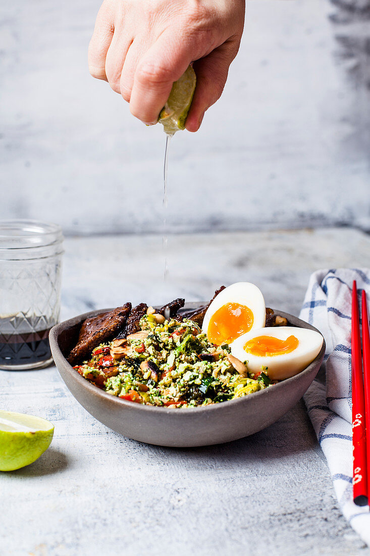 Thai style broccoli 'rice' with spicy dressing, eggs, and beef