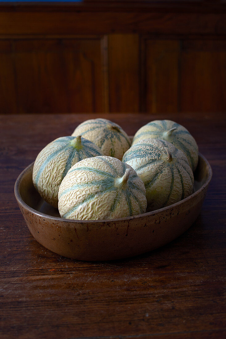 Mini melons in a ceramic bowl