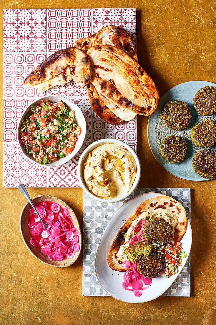 Homemade meze with hummus, falafel, pickled vegetables and tabbouleh