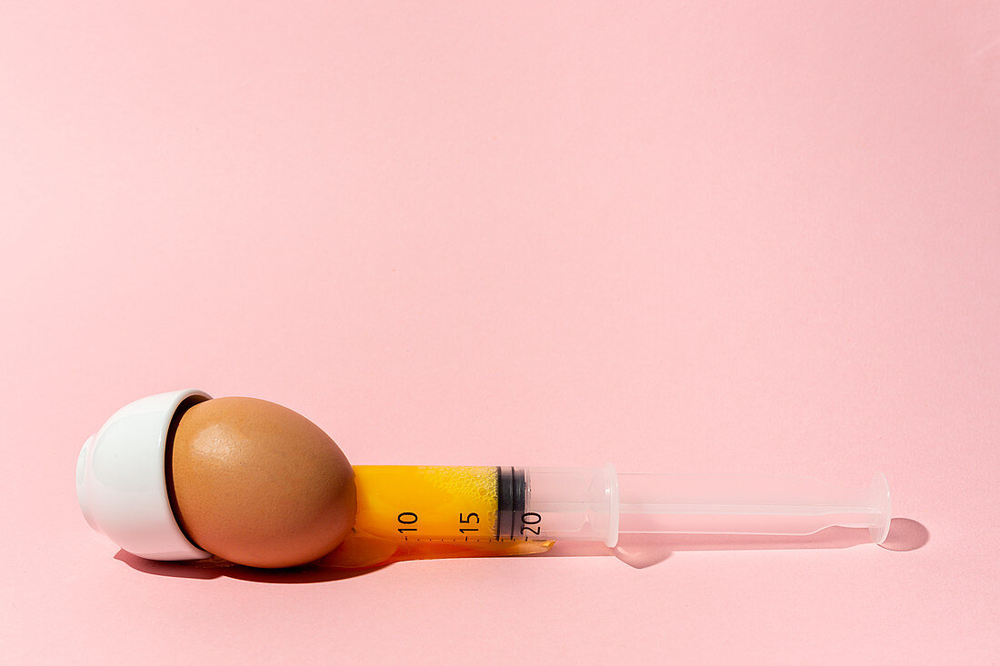 Egg with syringe in eggcup