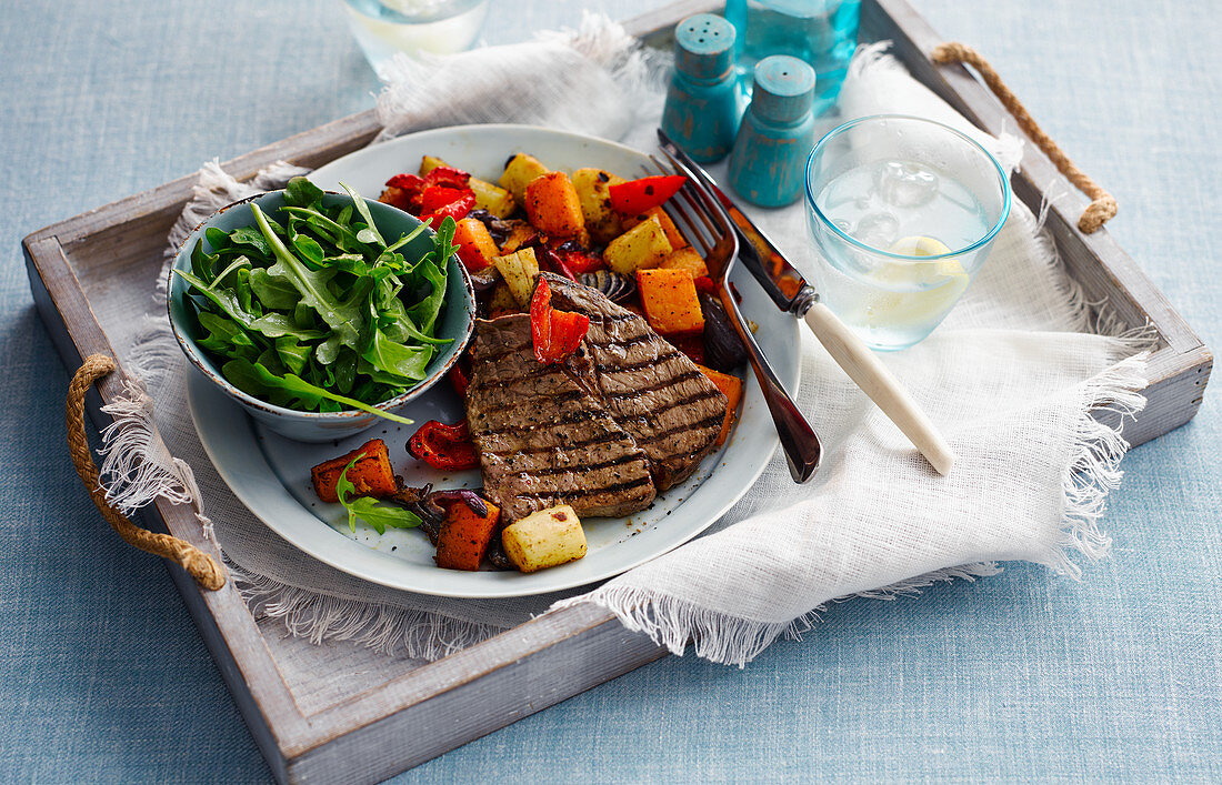 Grilled rump steak with roast vegetables and salad