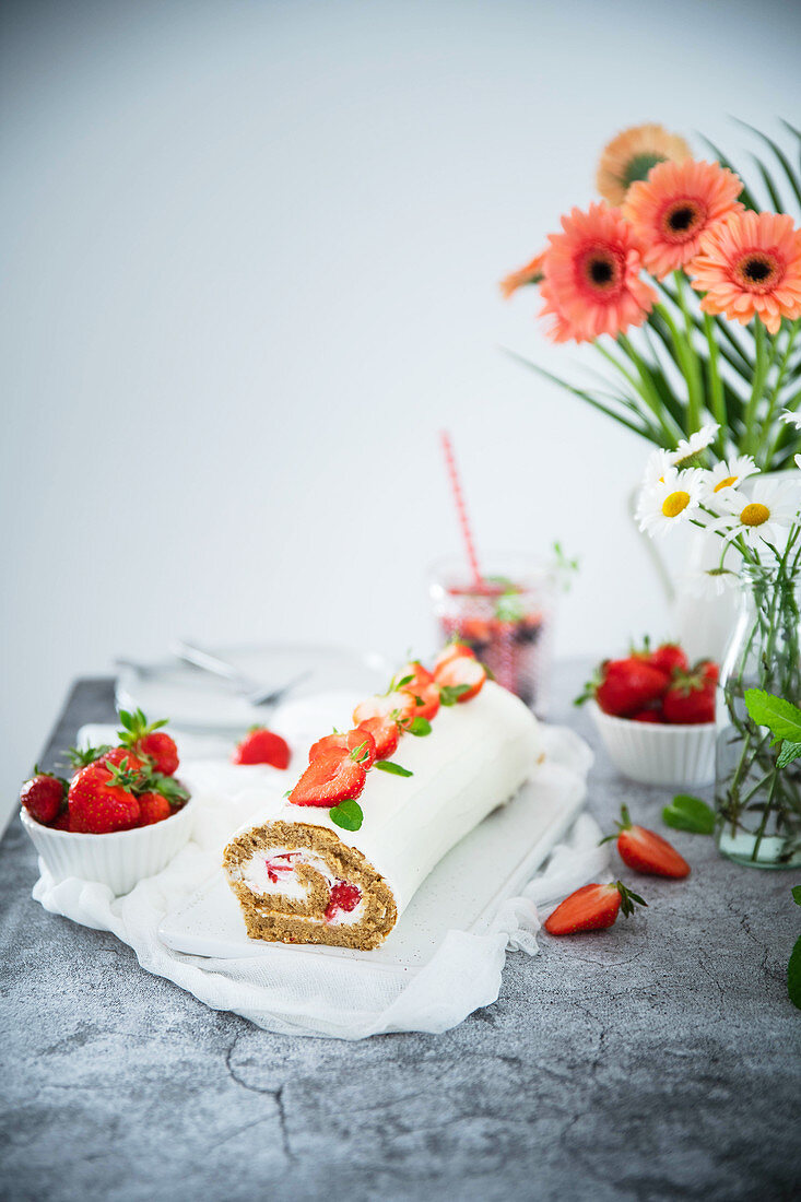 A wholegrain sponge roll with mascarpone cream and dressed with strawberries