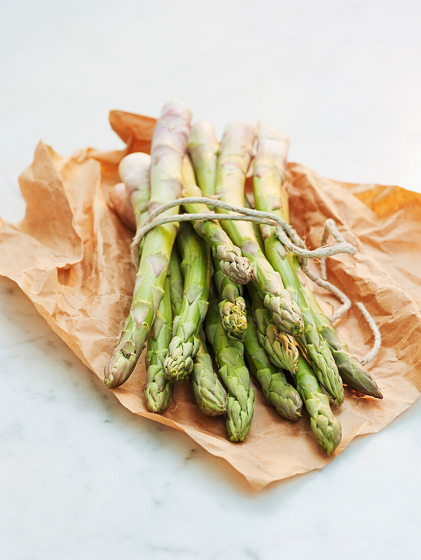 Green asparagus on wax paper